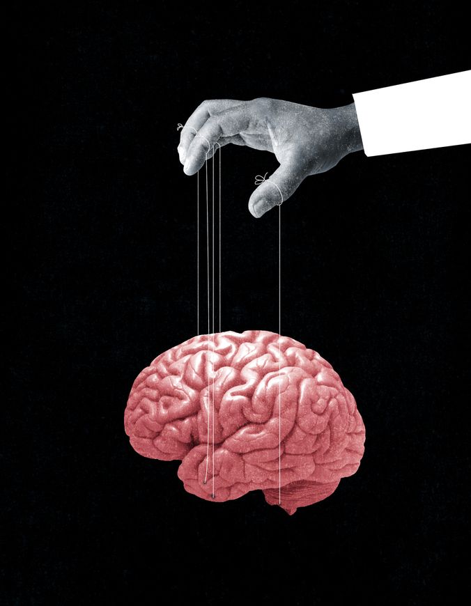 a hand is pulling strings from a human brain