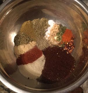 a metal bowl filled with spices and seasonings