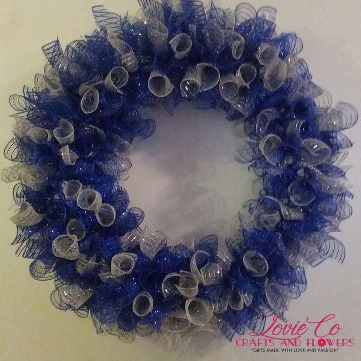 a blue and white wreath is hanging on the wall