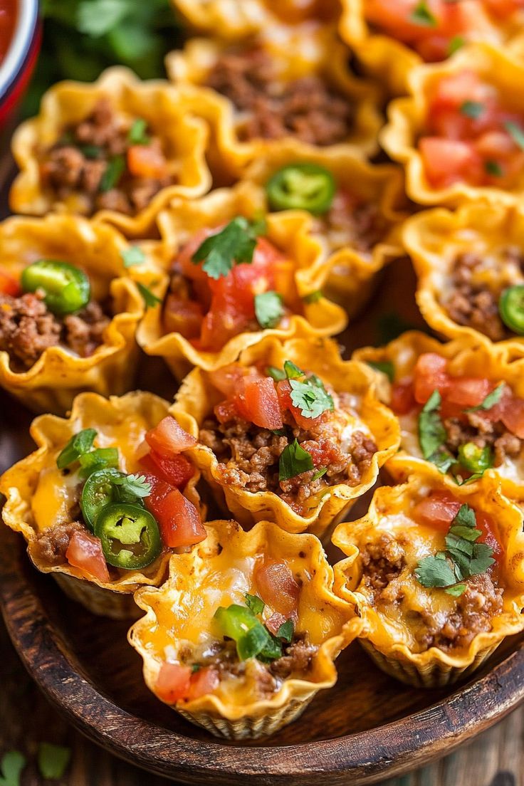 mini taco shells with meat and vegetables on a wooden platter