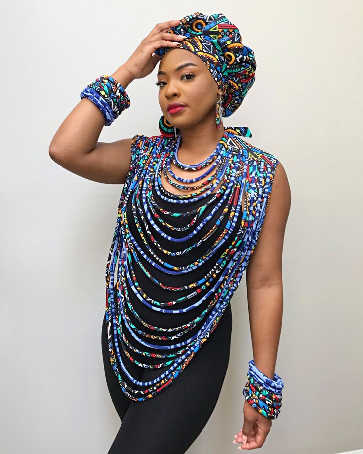 This necklace is a statement on its own. Put it over a simple slip black dress and you are the talk of the whole event. This is a true conversation starter.* 24 lines multi-strand Statement necklace* Fabric: 100% polyester satin African print* Color: Multi-colored, prominent navy blue and maroon*** Accessories ( Bonnet head wrap, bracelets and face masks) are available in-store. Sold separately. Slip Black Dress, Mans Clothes, African Fabric Accessories, Beige Accessories, Ankara Accessories, Afro Jewelry, South African Traditional Dresses, Necklace Fabric, African Beads Necklace