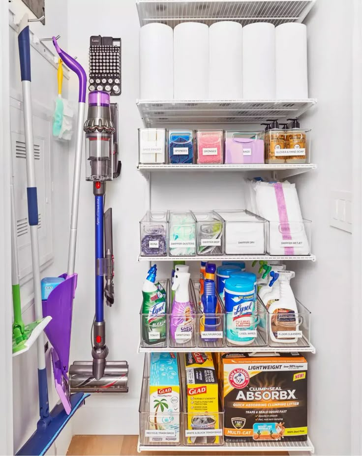 the closet is filled with cleaning supplies and other household care items, including a vacuum cleaner