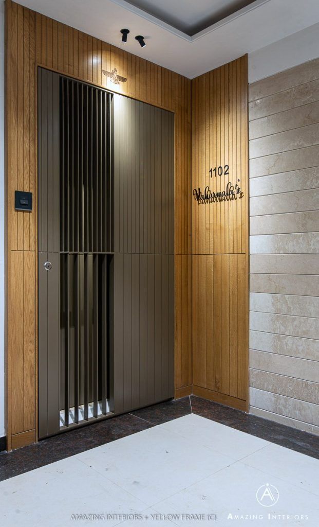 an elevator with wooden walls and metal doors