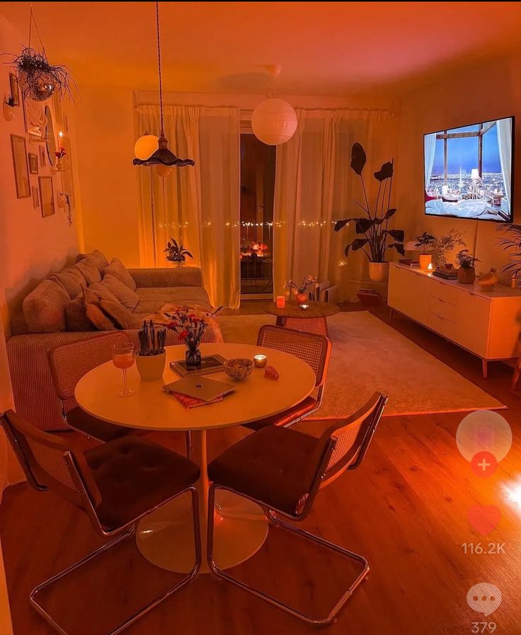 a living room filled with furniture and a flat screen tv mounted to the side of a wall