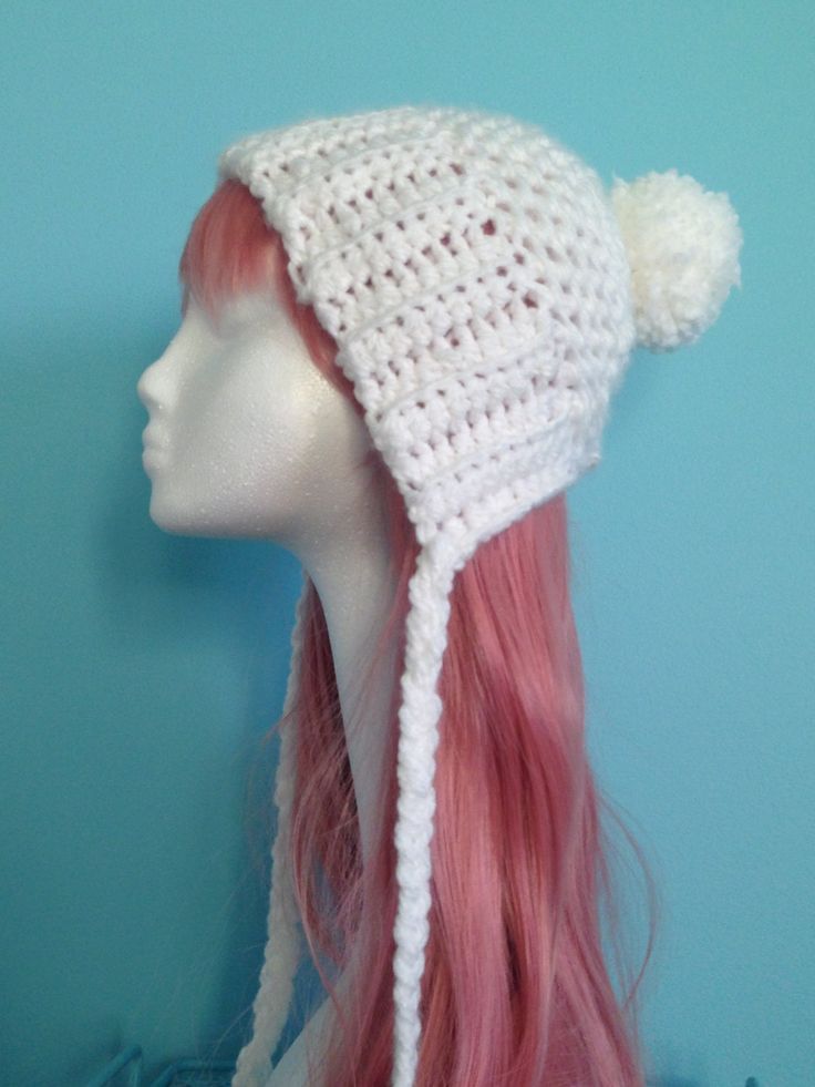 a white crocheted hat with pink hair