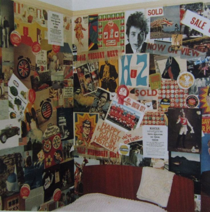 a bedroom wall covered in posters and magnets