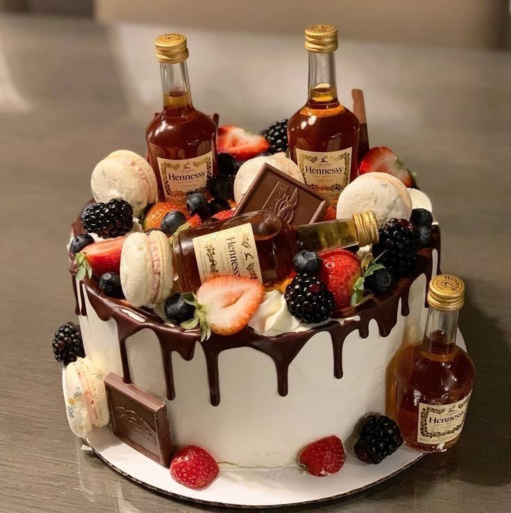 a cake covered in fruit and liquor on top of a table