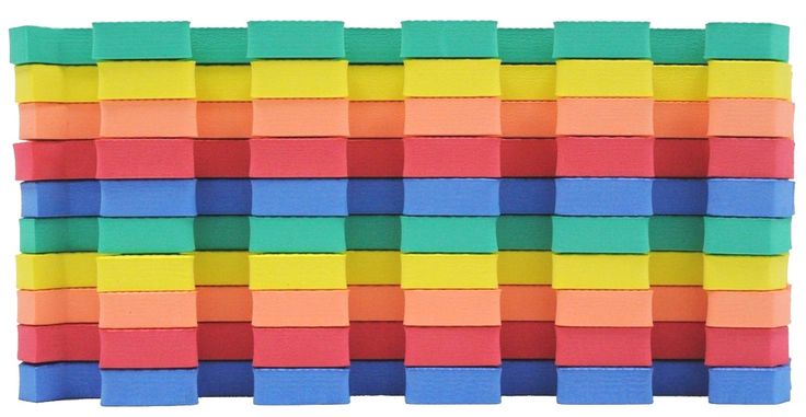 multicolored foam blocks are stacked on top of each other in order to form a wall