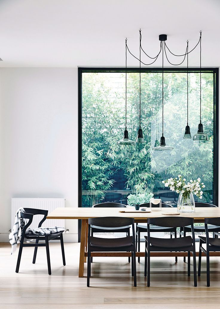 a table and chairs in front of a window with the words house and garden on it