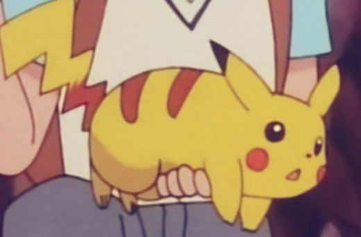 the pikachu is sitting on someone's lap