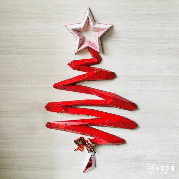 a christmas tree made out of red wooden planks and stars hanging from the ceiling