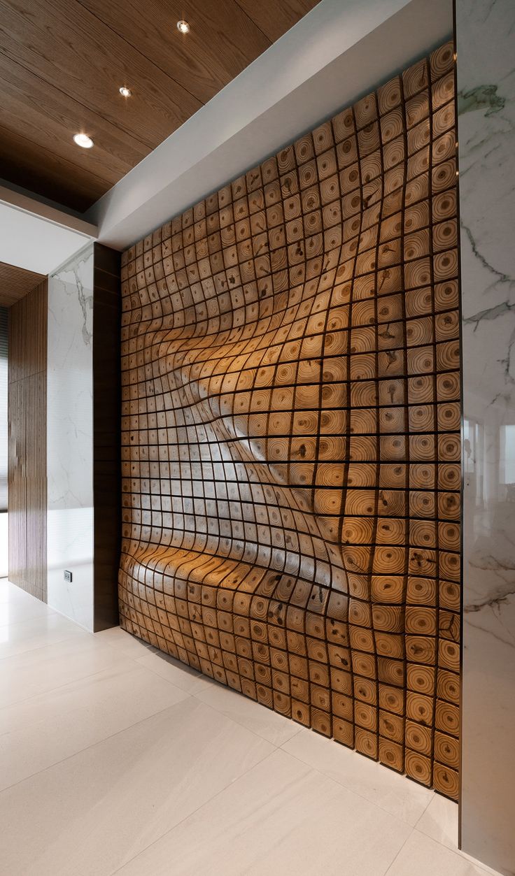 an artistic wall in the middle of a room with marble flooring and wood paneling