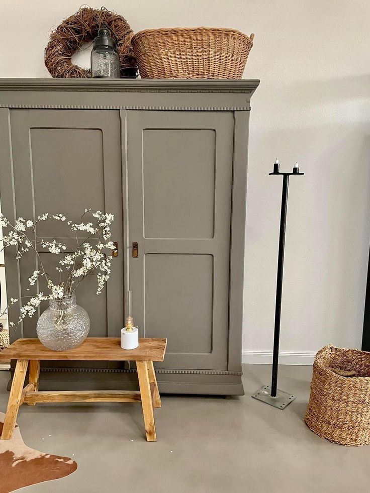 a living room with furniture and baskets on top of the cupboards next to each other