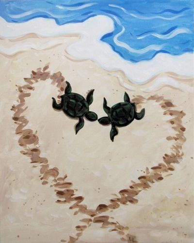 two turtles in the shape of a heart on a beach