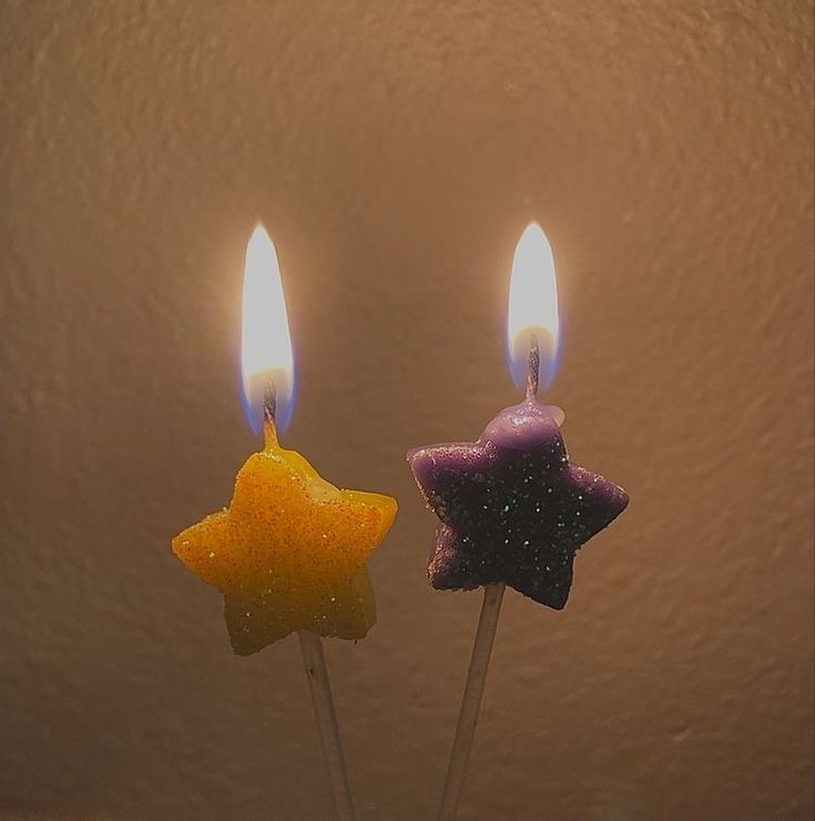 two candles that are shaped like stars