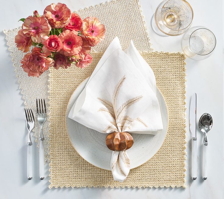 a place setting with flowers and silverware