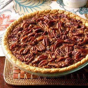 a pecan pie sitting on top of a wooden table