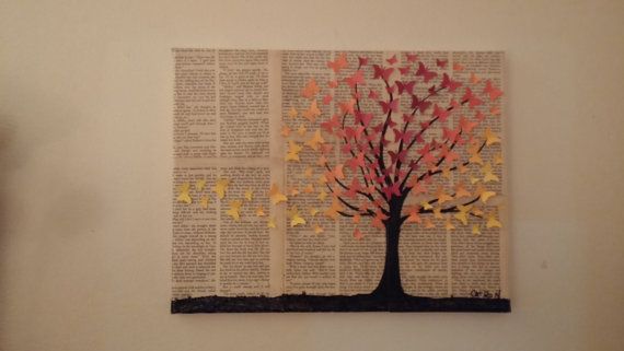 a book page with an image of a tree on it and butterflies in the shape of leaves