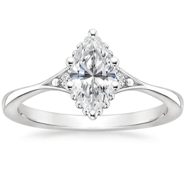 an engagement ring with a pear shaped diamond