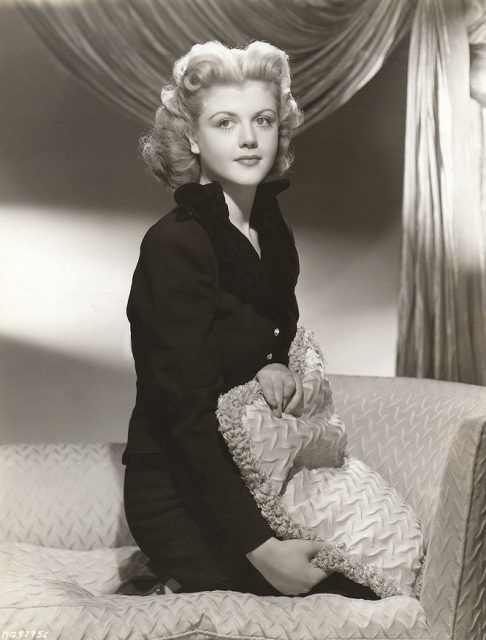 black and white photograph of a woman sitting on a couch