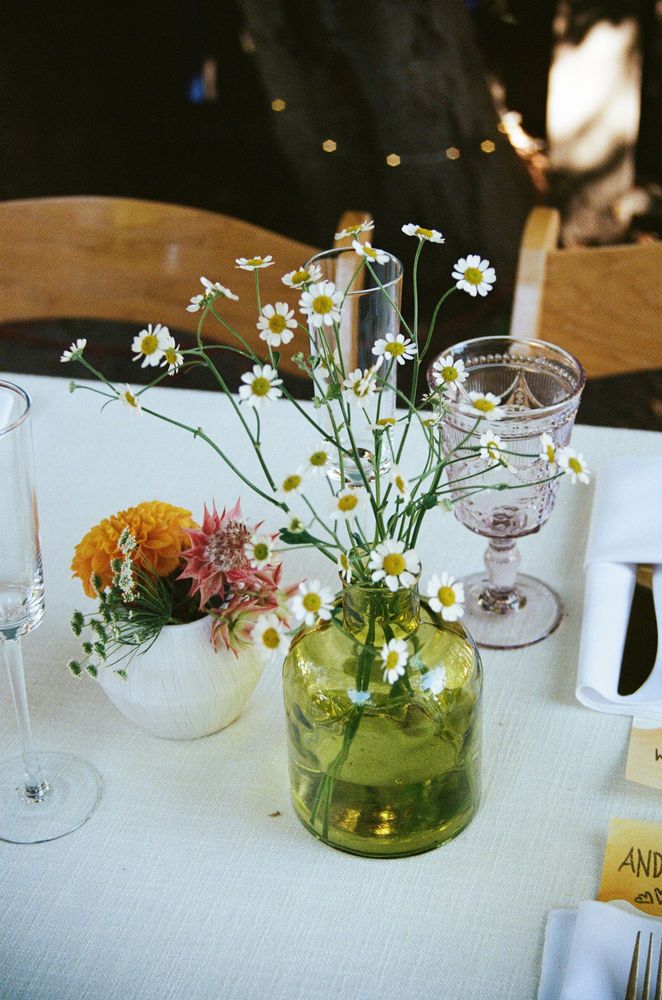 a table with flowers and wine glasses on it