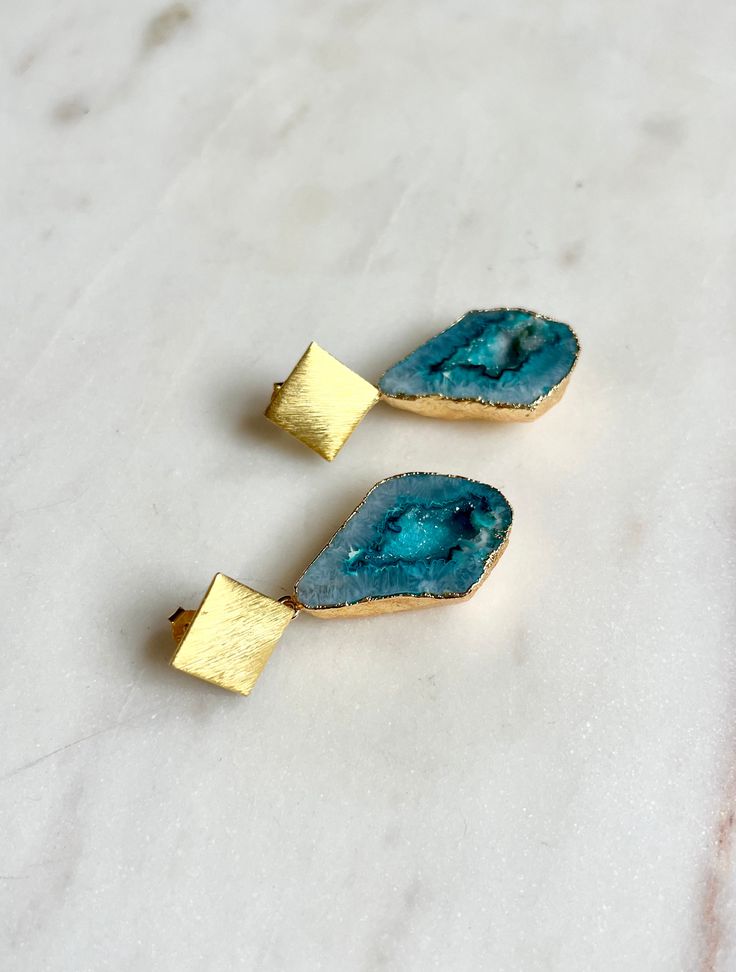 These stunning new Aqua Triangle Rocks Earrings are the perfect accessory to make a colourful statement. The stunning and unusual aqua geode stones have natural sparkly druzy inclusions and are beautifully contrasted against 18ct gold plated vermeil.   No two semi-precious gemstones are the same adding to the uniqueness of your piece. As these are natural stones, each piece will vary slightly from the image shown. The differences and natural inclusions in the aqua stones have been carefully sele Unique Turquoise Earrings With Patina, Luxury Agate Earrings With Natural Stones, Unique Agate Dangle Earrings, Unique Blue Agate Jewelry, Luxury Unique Agate Earrings, Aqua Stone, Unusual Earrings, Rustic Jewelry, Forever Jewelry