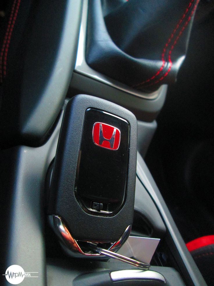 the interior of a car with a red stitching on the dash and steering wheel