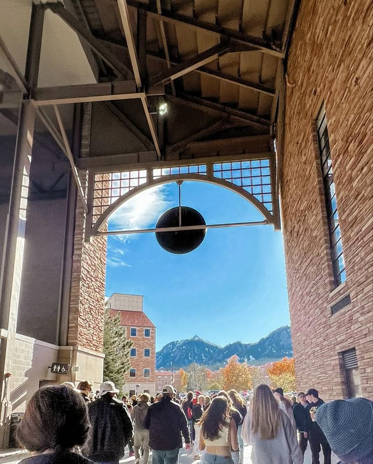 a group of people walking through an open building