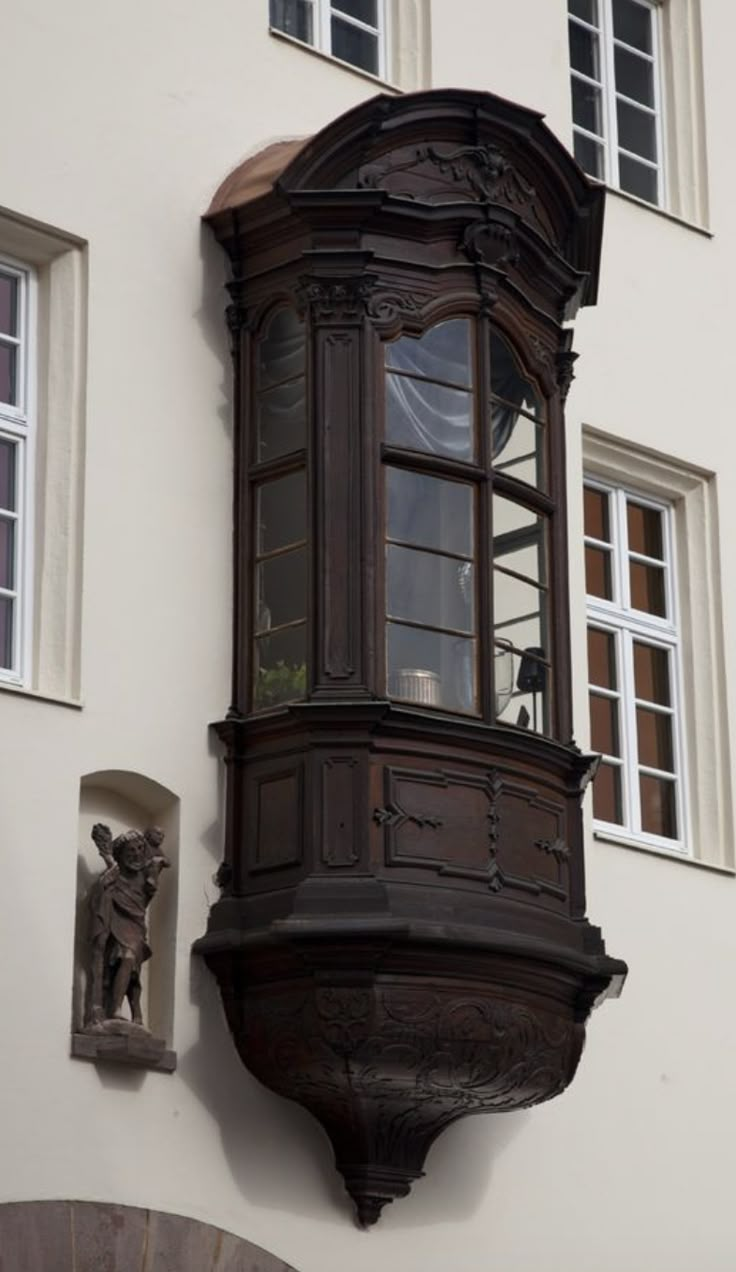 an old wooden clock on the side of a building