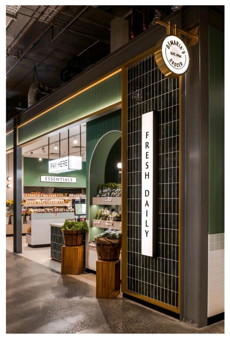 the inside of a grocery store with fresh produce on display and signs in front of it