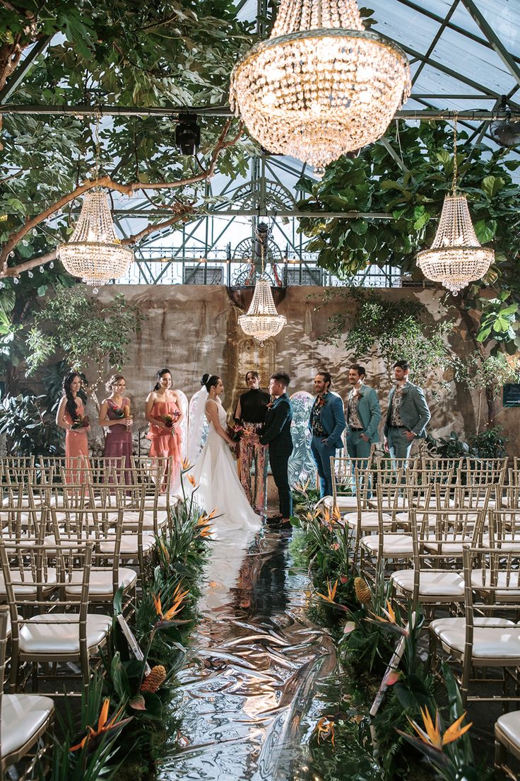 a bride and groom walking down the aisle at their wedding ceremony in an outdoor venue