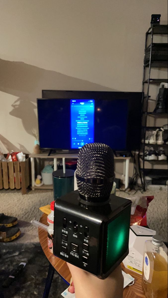 a microphone sitting on top of a table next to a tv