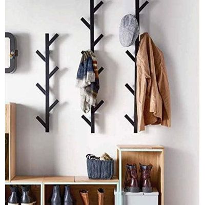 a coat rack with shoes hanging on the wall next to a shelf filled with coats