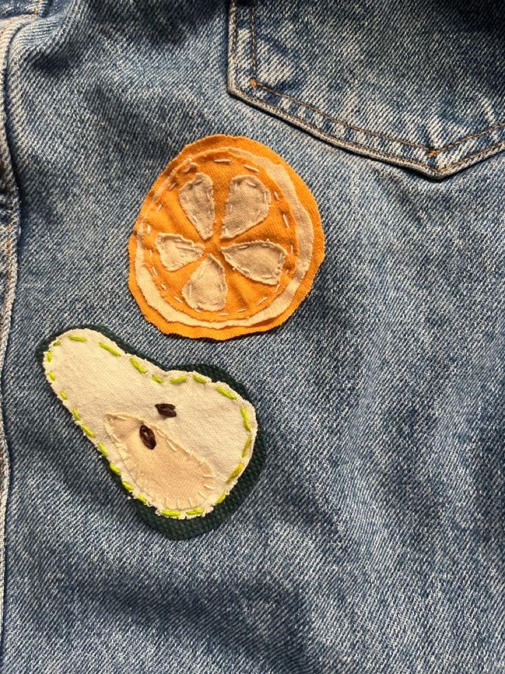 two pieces of fabric are placed on the back of a jean jacket