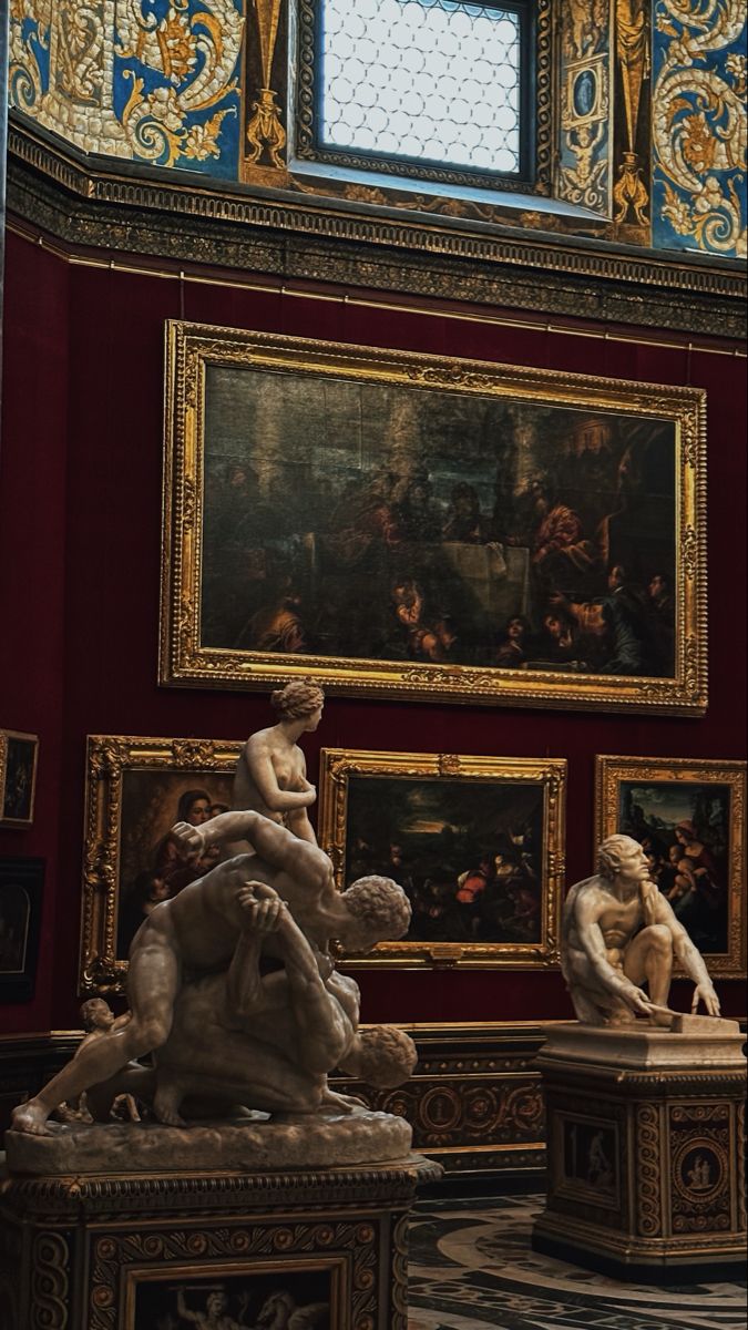 an ornate room with sculptures and paintings on the walls