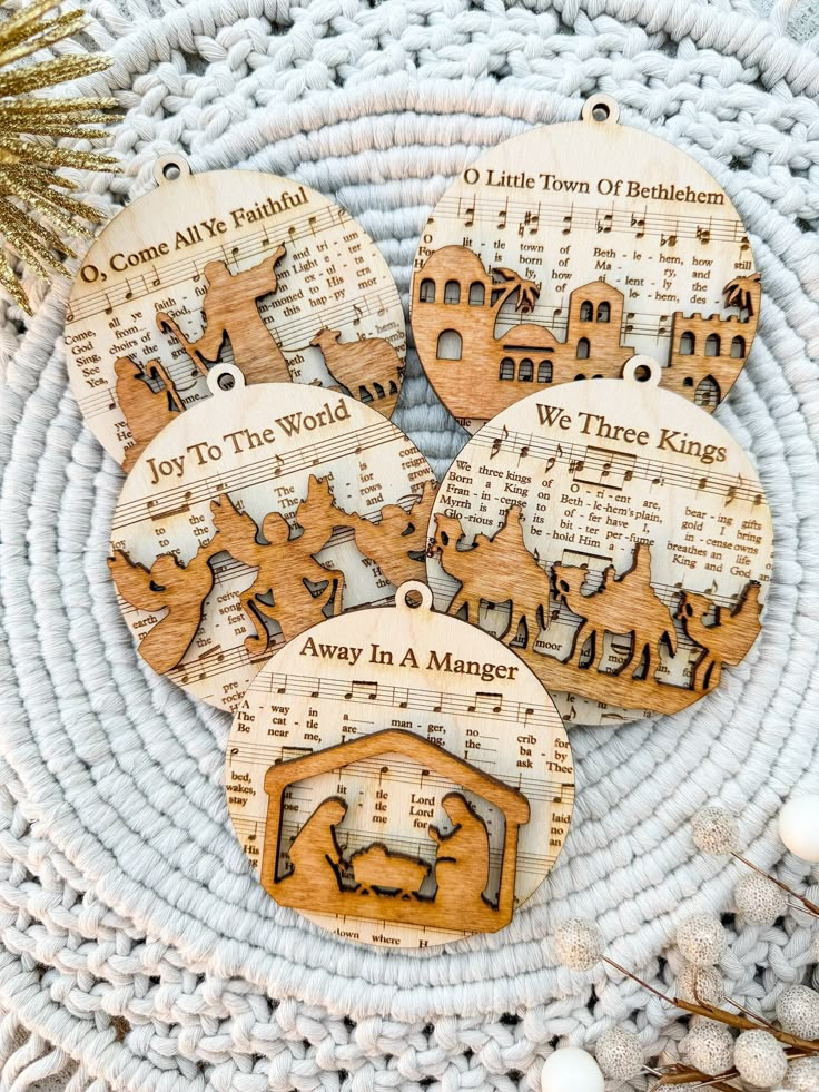 four wooden christmas ornaments sitting on top of a table