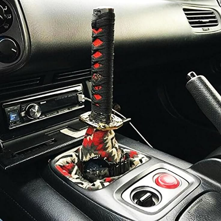 an elephant statue is sitting in the center console of a car, next to a steering wheel