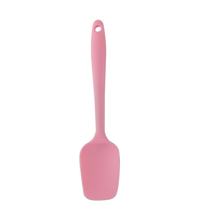 a pink spoon sitting on top of a white surface