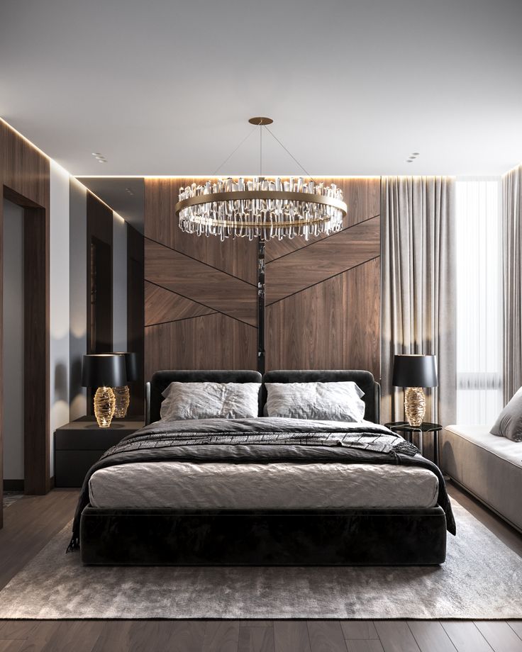 a bedroom with a large bed and chandelier