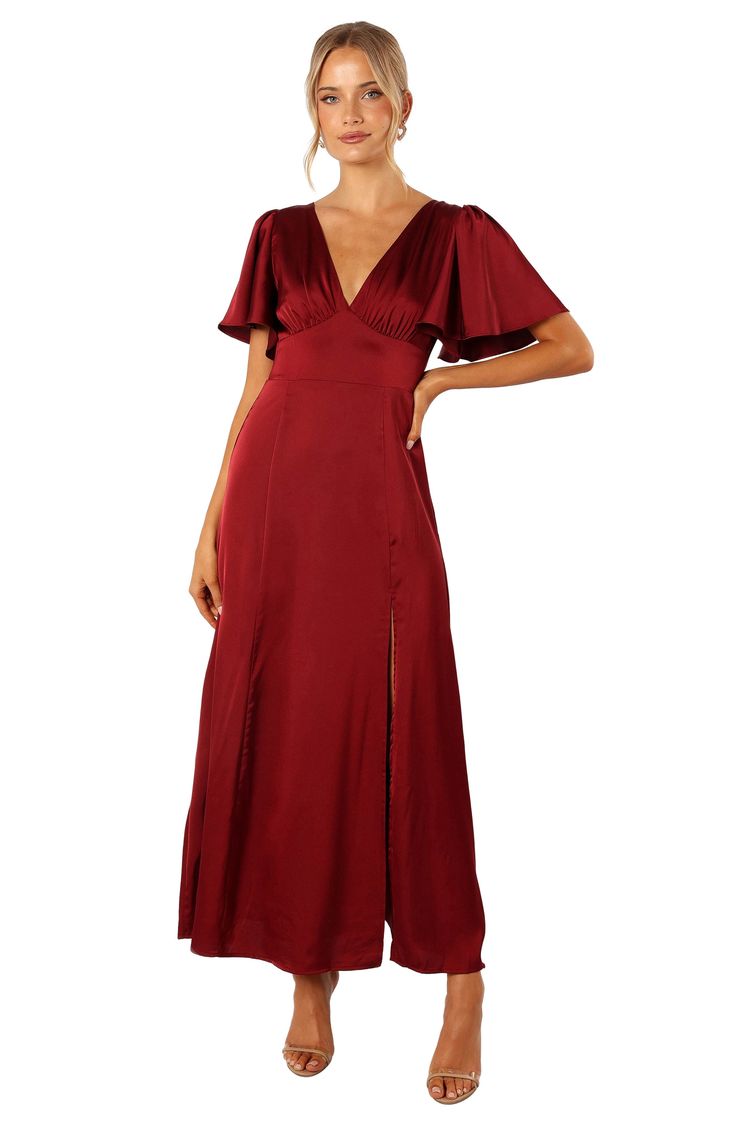 Elegant flutter sleeves add to the glamour of this flowy satin dress with back smocking. Back zip closure; ties behind neck V-neck Short sleeves Partially lined 100% polyester Hand wash, dry flat Imported Flowy Satin Dress, Stylish Maxi Dress, Petal And Pup, Short Sleeve Maxi Dress, Fall Wedding Guest, Fall Wedding Guest Dress, Guest Attire, Wedding Attire Guest, Short Sleeve Maxi Dresses