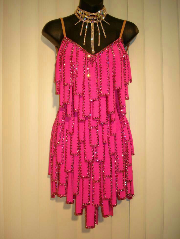 a woman's pink dress hanging up on a mannequin headdress