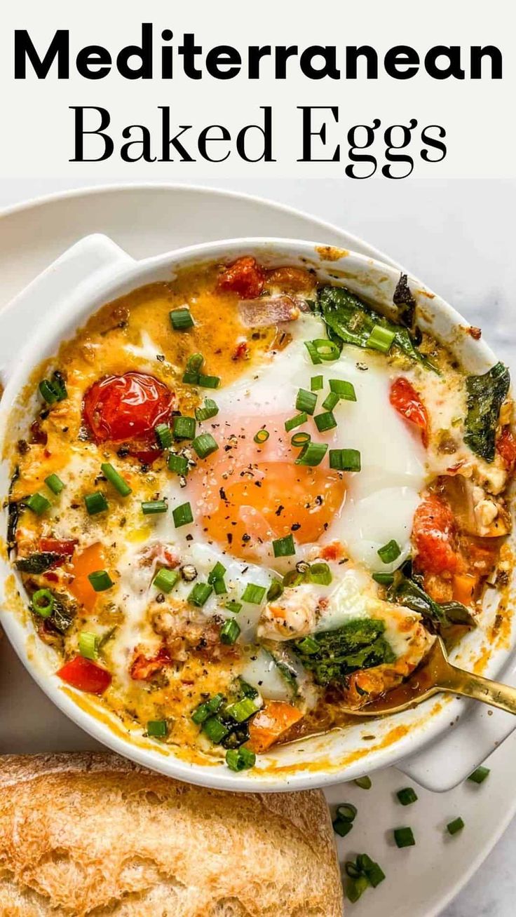 a white plate topped with an egg and vegetables next to a slice of bread on top of it