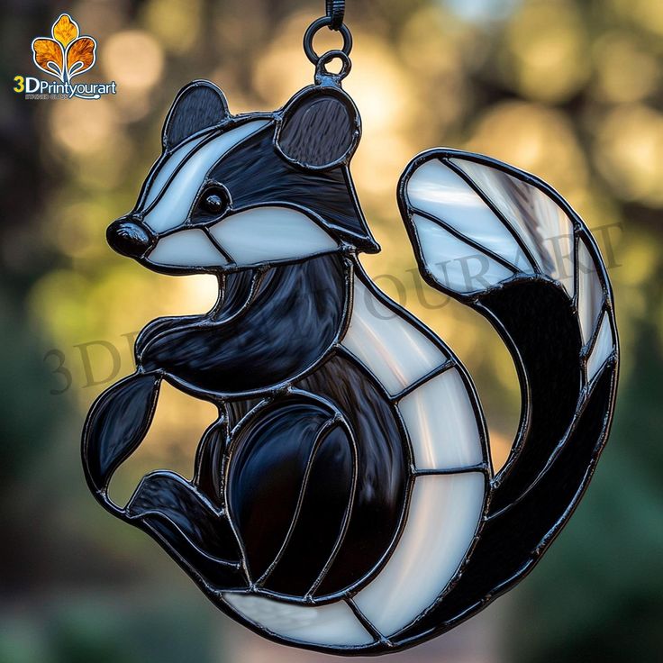 a stained glass squirrel ornament hanging from a chain