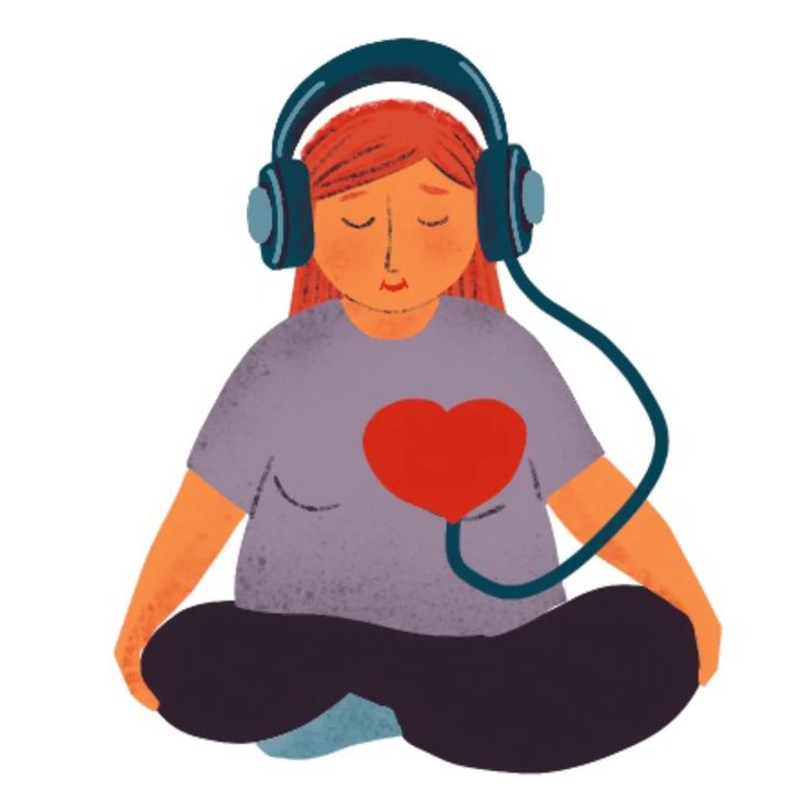 a woman with headphones and a heart on her chest sitting in the middle of a yoga pose