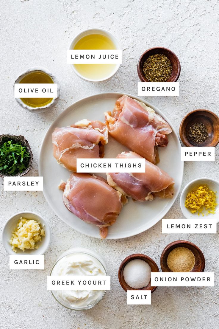 the ingredients for chicken thighs on a white plate