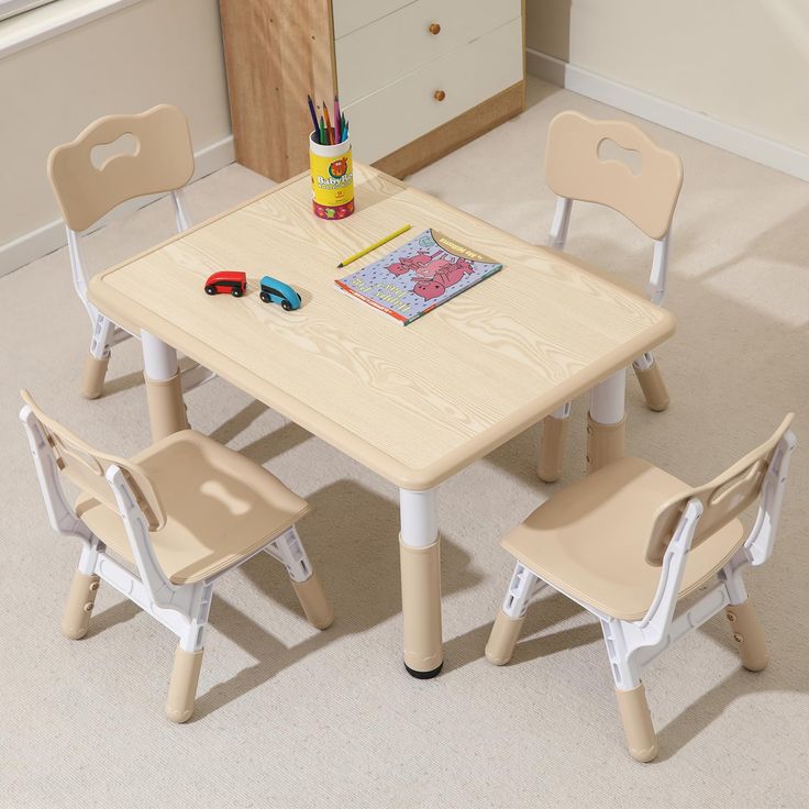 a child's table and chair set in a room with carpeted flooring