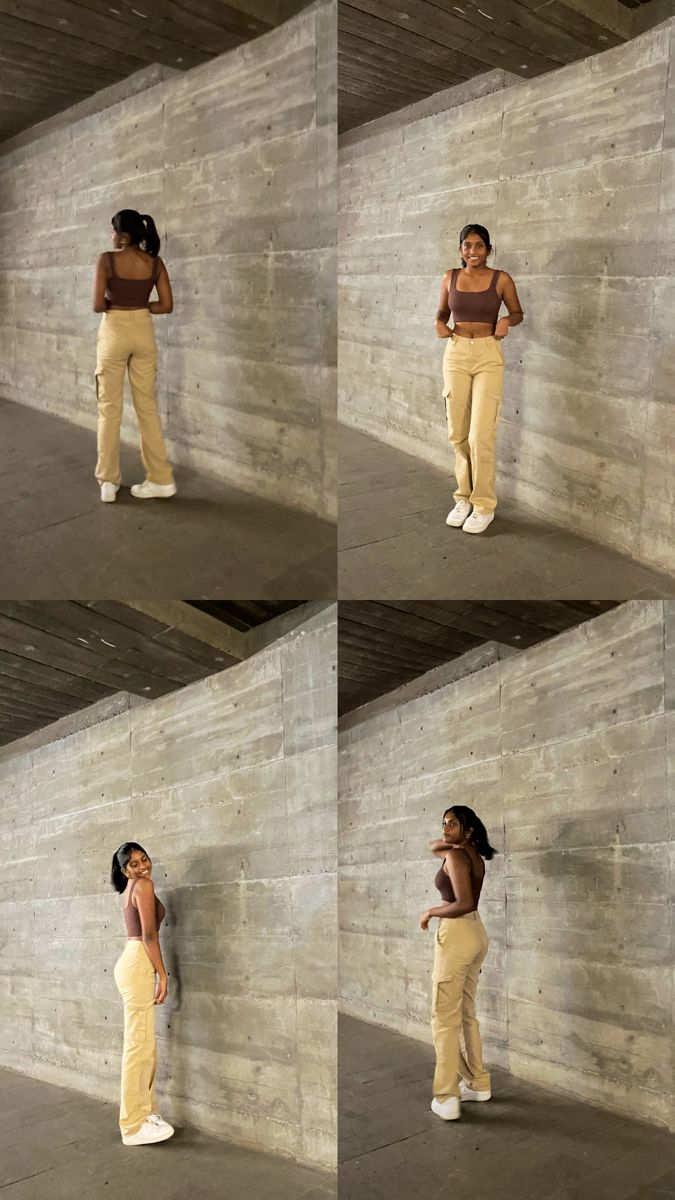 a woman leaning against a wall and talking on her cell phone