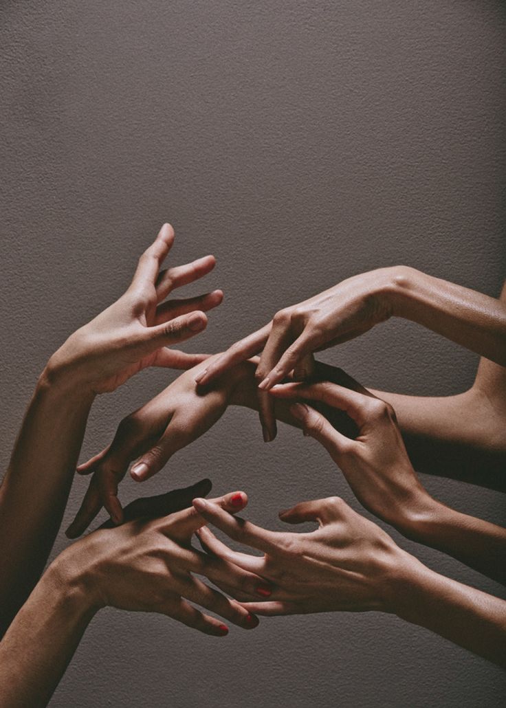 many hands reaching for each other in the air