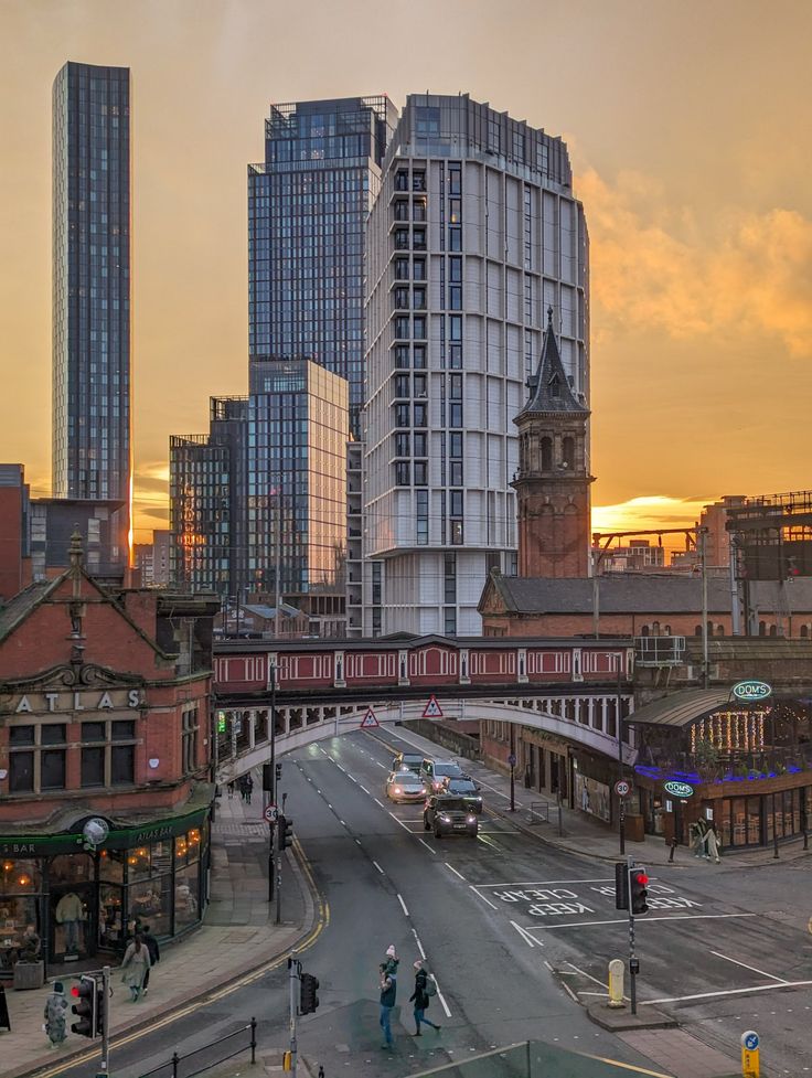 a city street with tall buildings in the background