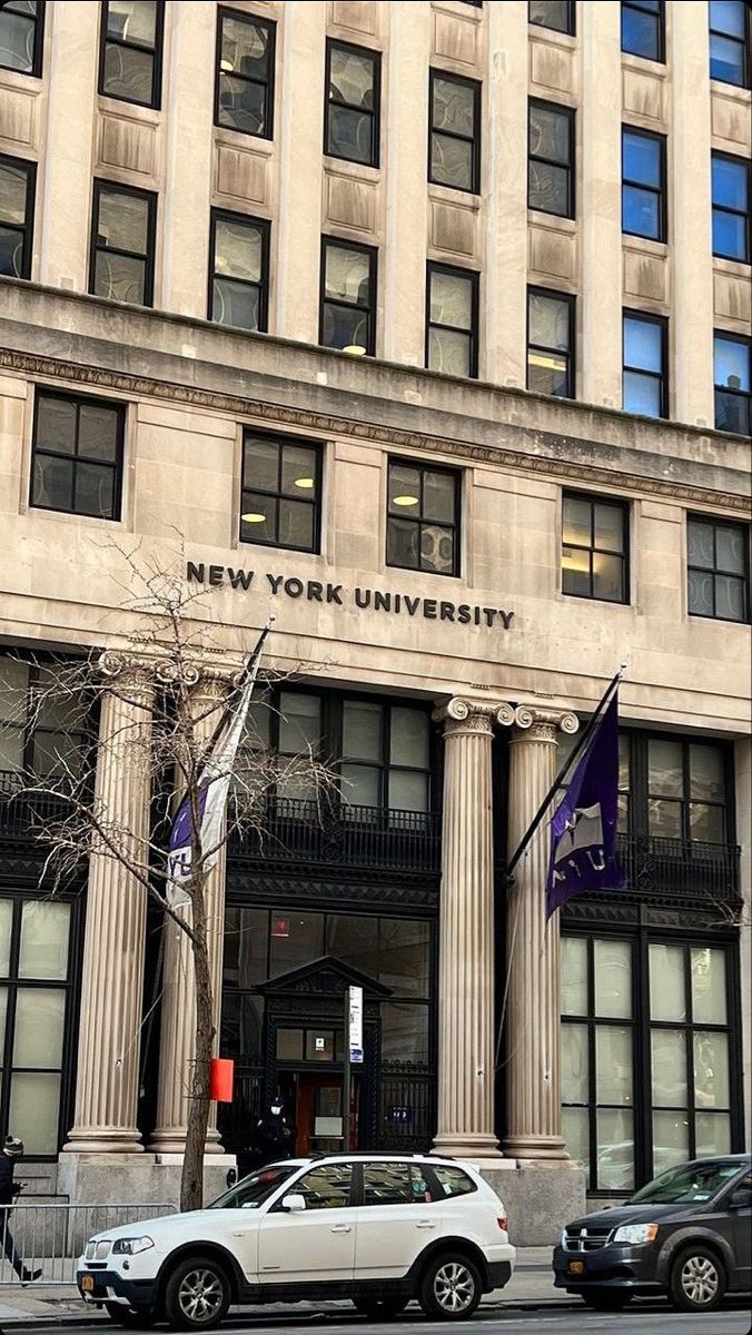 the new york university building is shown with cars parked in front